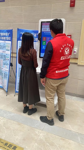 6.市婦幼保健院志愿者指導(dǎo)群眾使用自助服務(wù)多功能一體機_副本.jpg